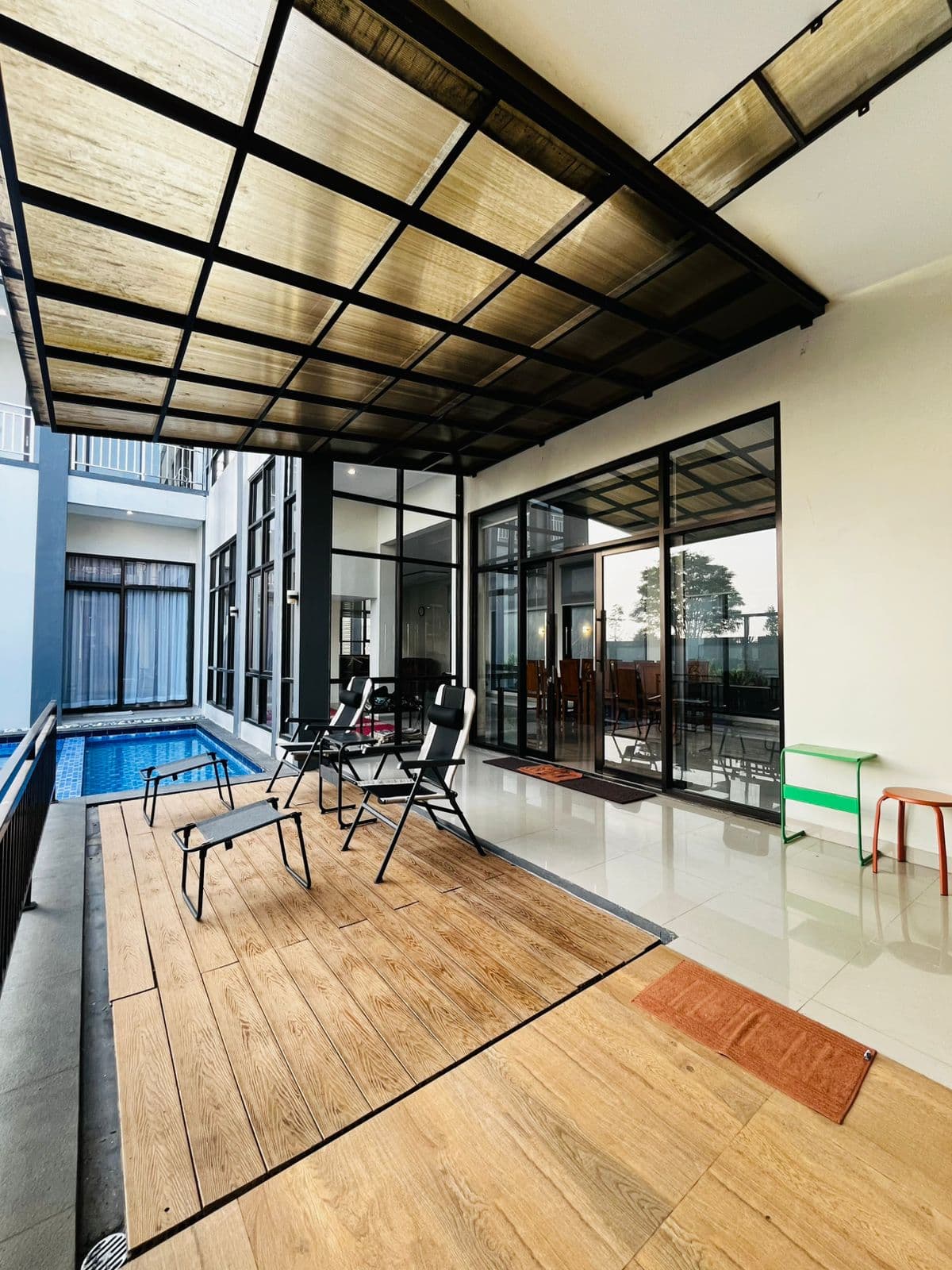 Poolside terrace seen from inside the villa's glass doors