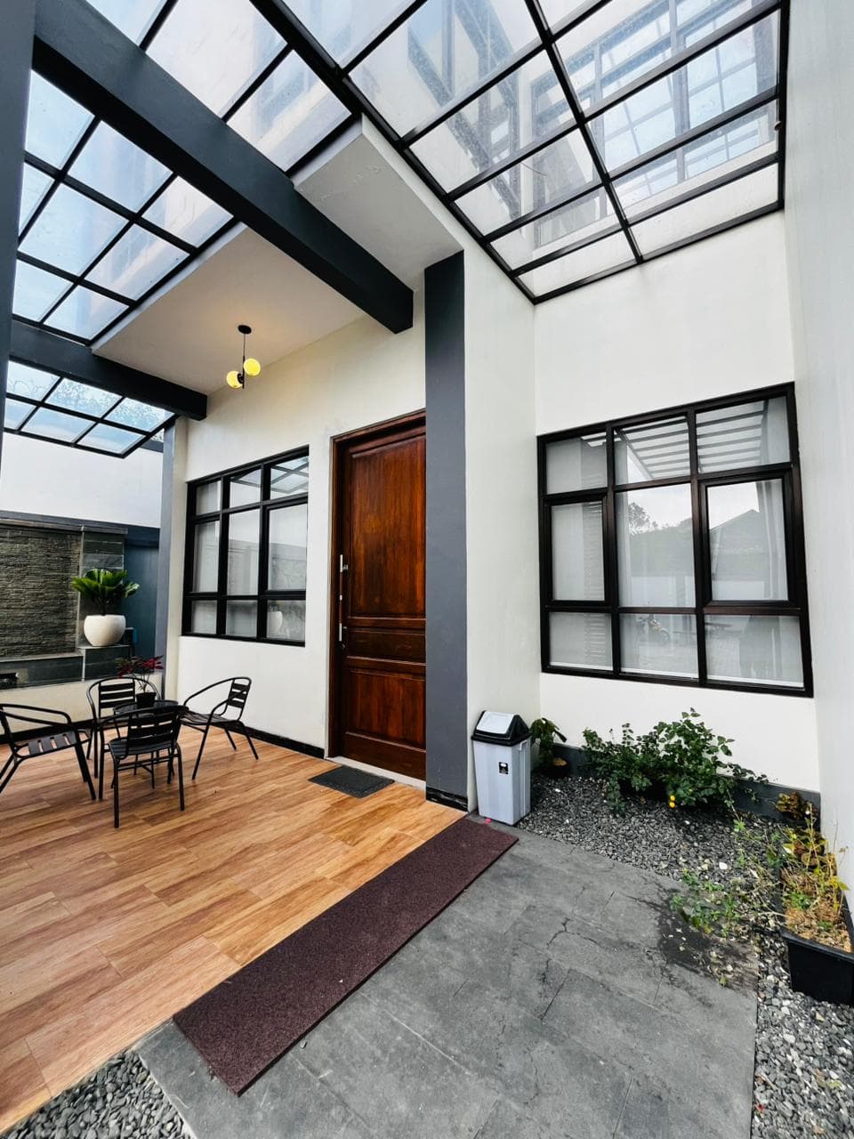 Entrance courtyard with a glass canopy and wooden door