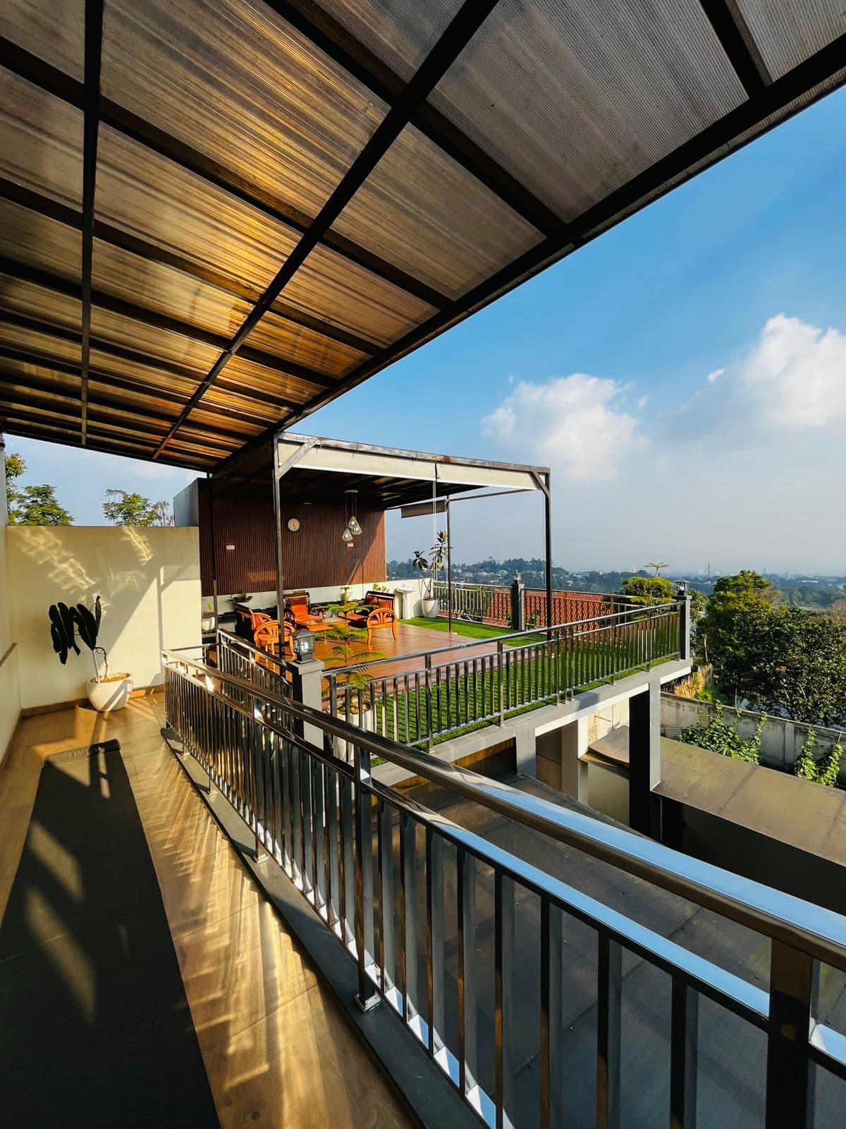 Covered upper walkway at the villa opening onto the green Lembang valley