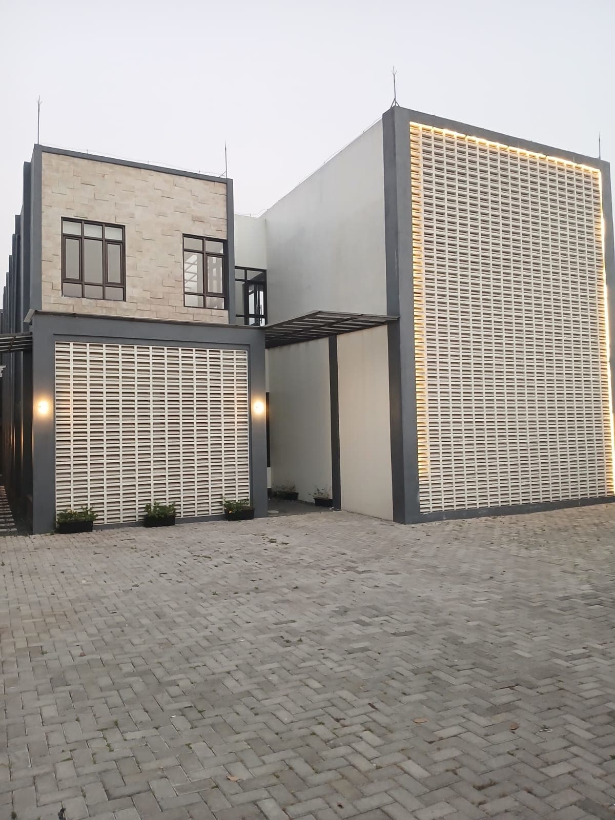The villa facade and gated forecourt from the street