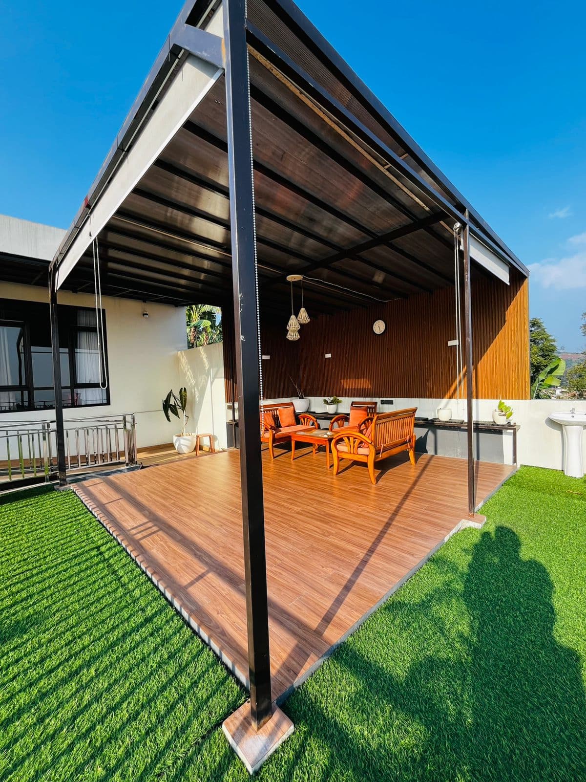 Wooden deck and lawn beside the gazebo at diVillaDhiya
