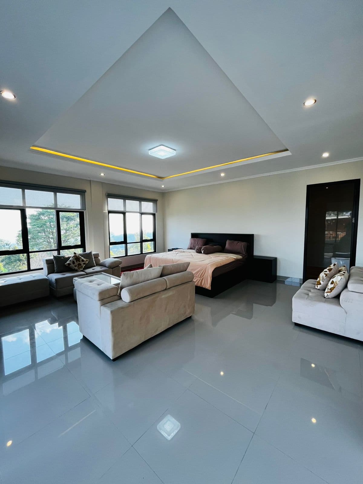 Bright bedroom with a seating area and garden windows