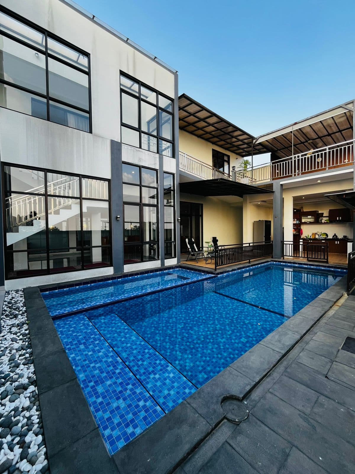 The villa pool at diVillaDhiya, with the house facade rising behind it